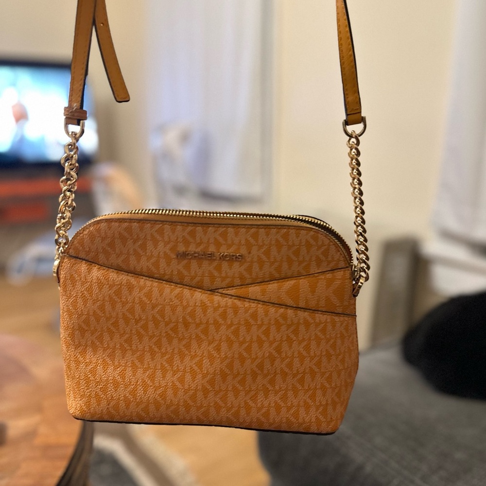 jet set travel medium signature logo dome crossbody bag orange